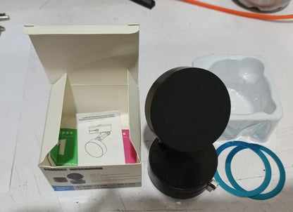 Black magnetic phone holder with packaging box and mounting accessories on white surface