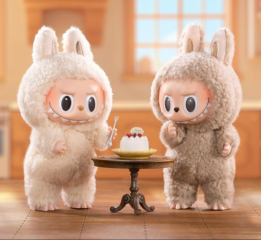 Pop Mart Labubu limited edition plush figures in bunny costumes with a small cake on a table
