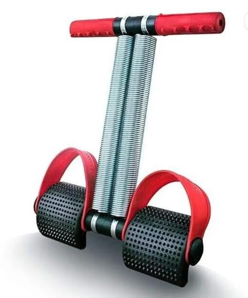 Ab exerciser for home workouts with dual metal springs and red cushioned handles and foot pedals